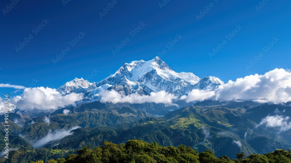 The mountain range is covered in snow and the sky is clear and blue. The clouds are scattered throughout the sky, giving the scene a peaceful and serene atmosphere The mountain range is covered in snow and the sky is clear and blue. The clouds are scattered throughout the sky, giving the scene a peaceful and serene atmosphere