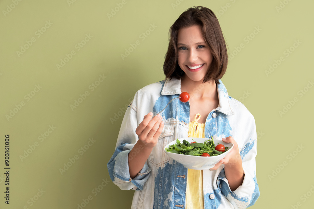 Beautiful young happy woman with bowl of fresh healthy salad on green background. Diet concept Beautiful young happy woman with bowl of fresh healthy salad on green background. Diet concept