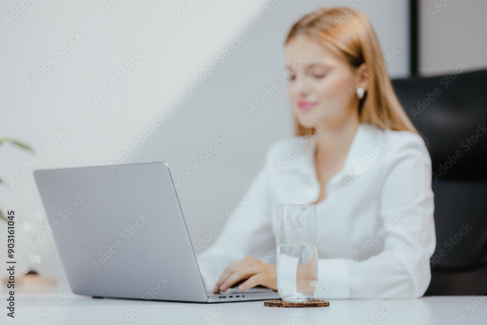 Businesswoman working on laptop at office Businesswoman working on laptop at office