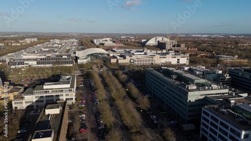 Medium aerial parallax shot of Milton Keynes City Centre, showing Midsummer Place and Xscape, with East MK in the background