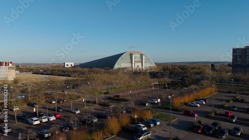 Wide aerial dolly shot of Milton Keynes Xscape, car park in the foreground