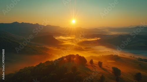 Mountain range at sunrise, misty valleys, and golden light 