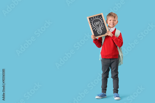 Little schoolboy holding ch...