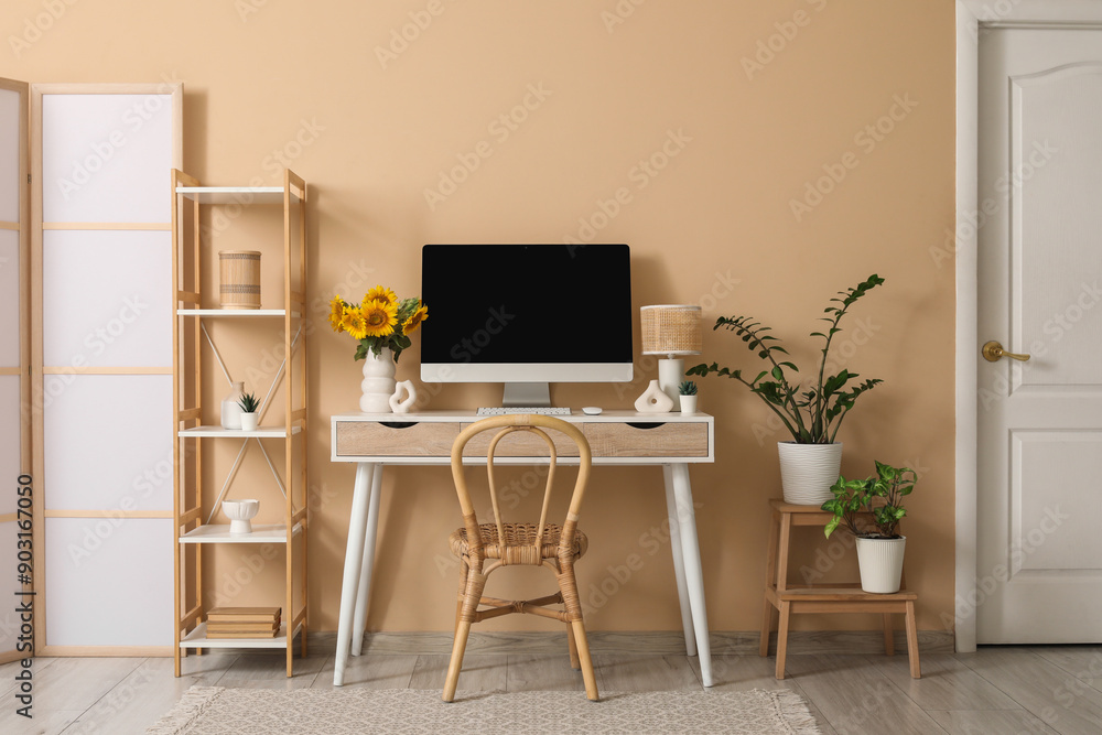 Interior of office with workplace, shelf unit and plants Interior of office with workplace, shelf unit and plants