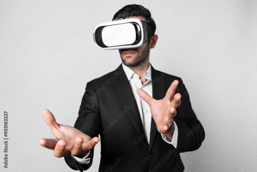 Professional business man holding something while using VR glasses to enter metaverse. Project manager looking at data analysis while wearing suit and virtual reality goggles. Innovation. Deviation. Professional business man holding something while using VR glasses to enter metaverse. Project manager looking at data analysis while wearing suit and virtual reality goggles. Innovation. Deviation.