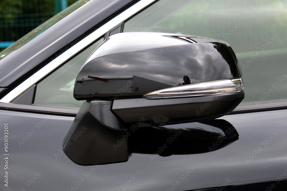 New Black Electric SUV rear view mirror. Lux electric car folded mirror. Side rear-view mirror on a modern car. Close up rearview mirror lux SUV. New Black Electric SUV rear view mirror. Lux electric car folded mirror. Side rear-view mirror on a modern car. Close up rearview mirror lux SUV.