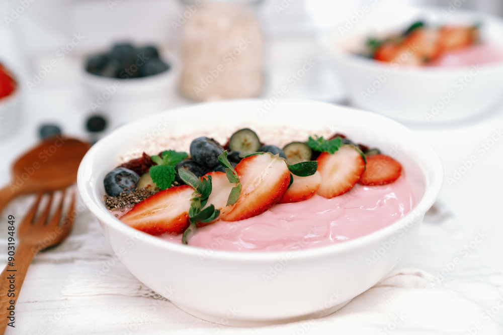 Presented by fruits putting yogurt toppings with strawberry, berry, oats, raisins and chia seed decorated by peppermint in white blow. Pink background. Set of healthy dairy product choice. Pecuniary. Presented by fruits putting yogurt toppings with strawberry, berry, oats, raisins and chia seed decorated by peppermint in white blow. Pink background. Set of healthy dairy product choice. Pecuniary.