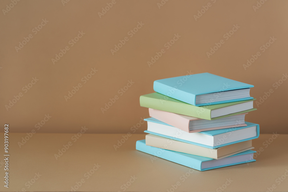 Stack of blue books on a brown background with soft shadow, copy space. Book Lovers Day concept Stack of blue books on a brown background with soft shadow, copy space. Book Lovers Day concept