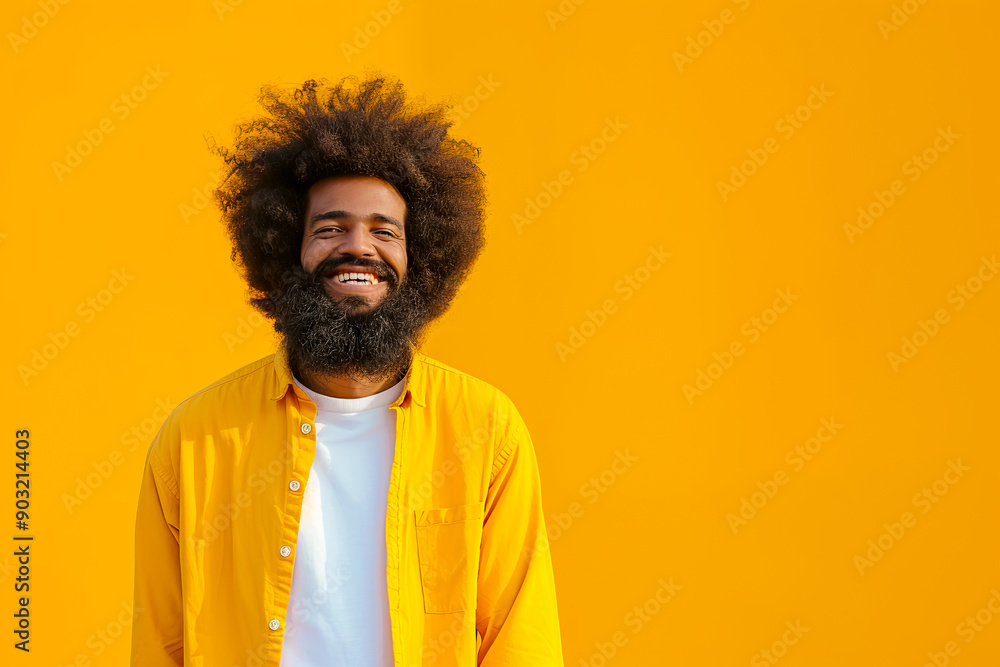 Portrait of a bearded laughing man in a yellow shirt on a smoky yellow background with space for a sports concept Portrait of a bearded laughing man in a yellow shirt on a smoky yellow background with space for a sports concept