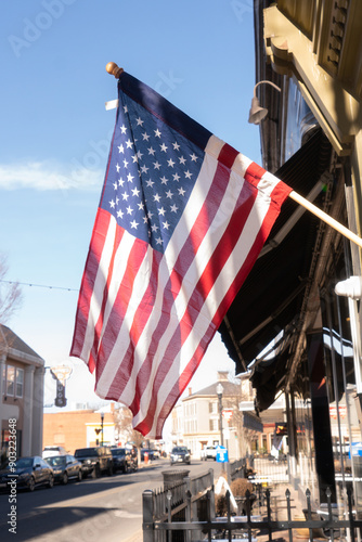 Old Glory, American flag on display outside of a small business in Main Street America