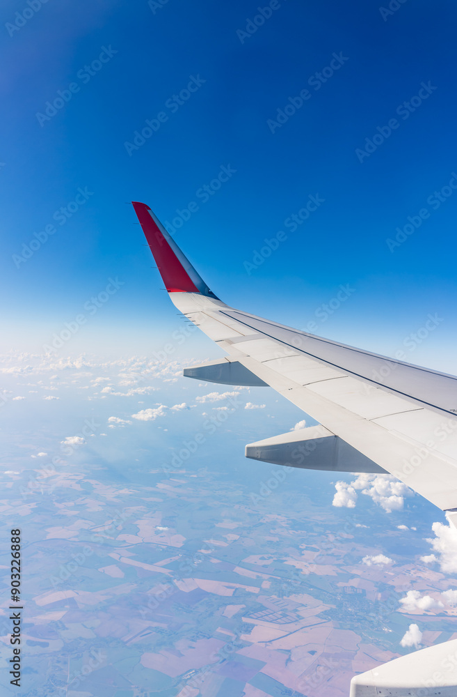 View from the airplane window at a beautiful cloudy sky and the airplane wing View from the airplane window at a beautiful cloudy sky and the airplane wing