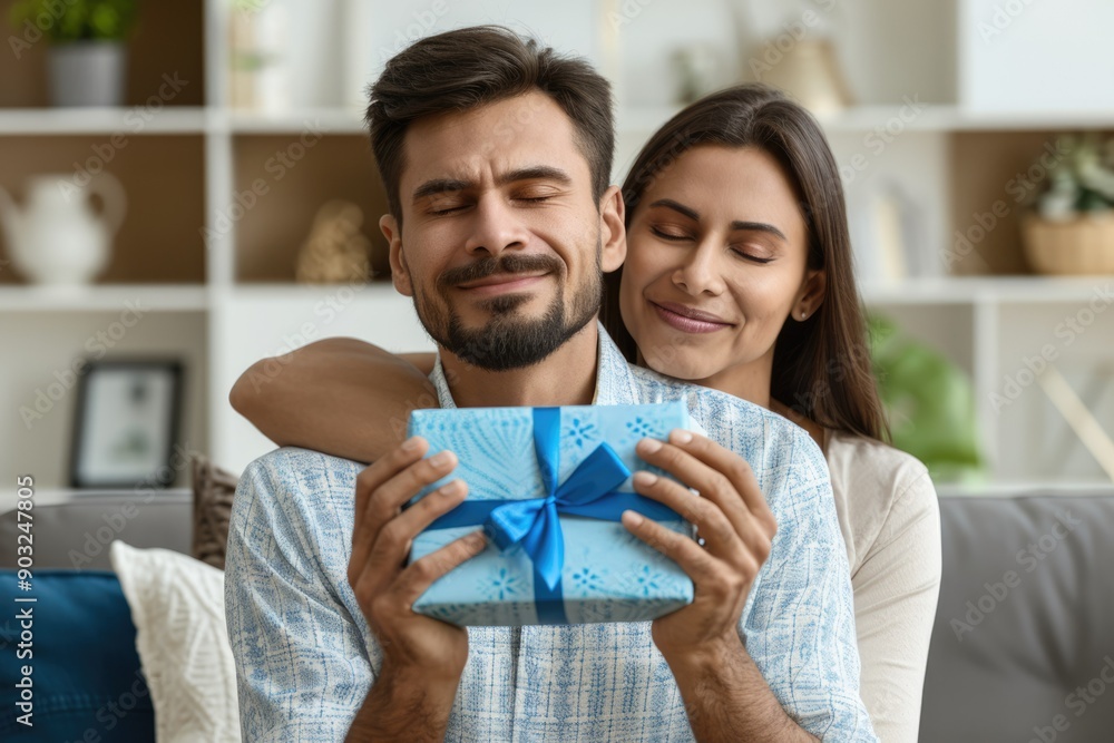 Fototapeta premium Indian man surprises wife with gift during Raksha Bandhan.
