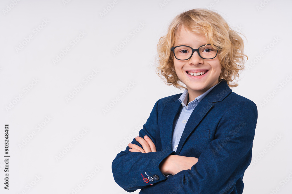 Close up portrait of a caucasian blonde preteen elementary primary middle school pupil boy kid child with arms crossed wearing uniform eyeglasses on white background, copy space. Education concept Close up portrait of a caucasian blonde preteen elementary primary middle school pupil boy kid child with arms crossed wearing uniform eyeglasses on white background, copy space. Education concept
