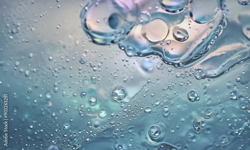 Celestial Bubbles: A mesmerizing macro photograph capturing the ethereal beauty of iridescent bubbles suspended in a translucent blue liquid, resembling a miniature galaxy of pearlescent orbs.