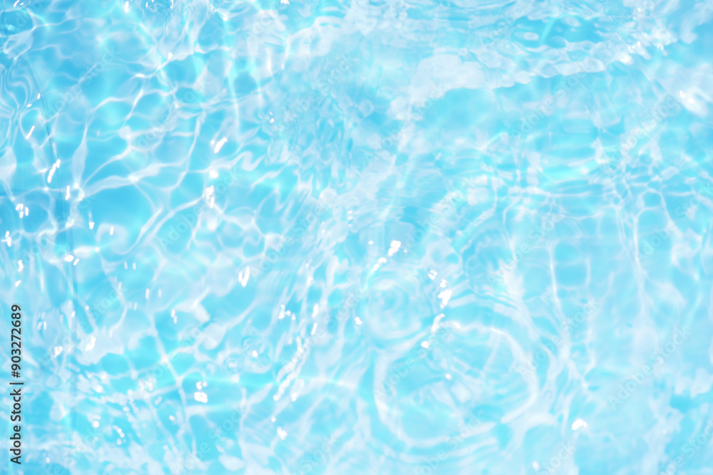 Blue water with ripples on the surface. Defocus blurred transparent blue colored clear calm water surface texture with splashes and bubbles. Water waves with shining pattern texture background. Blue water with ripples on the surface. Defocus blurred transparent blue colored clear calm water surface texture with splashes and bubbles. Water waves with shining pattern texture background.