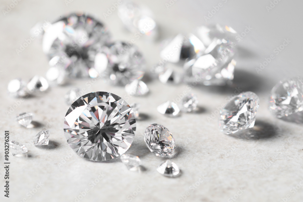 Many beautiful shiny diamonds on light background, closeup Many beautiful shiny diamonds on light background, closeup
