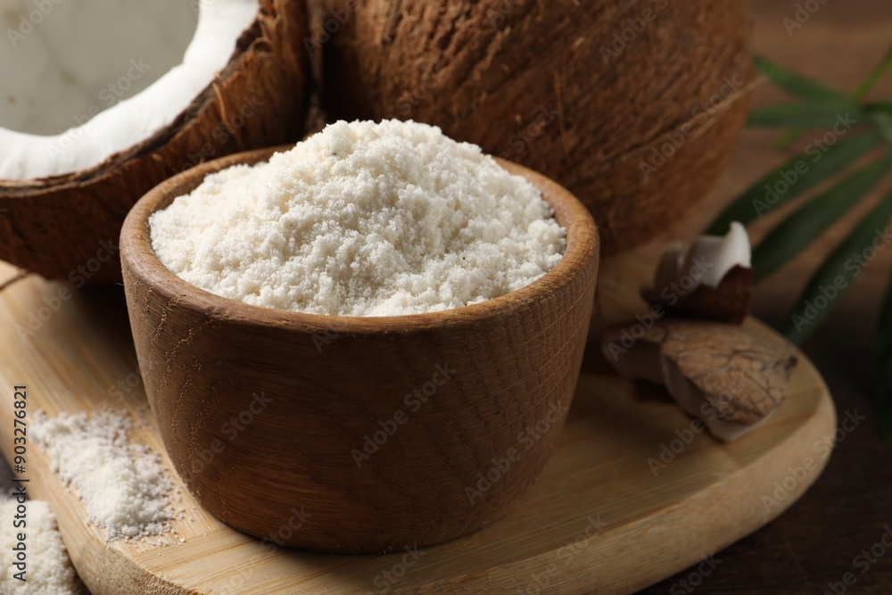 Coconut flour in bowl and fresh fruits on table, closeup Coconut flour in bowl and fresh fruits on table, closeup