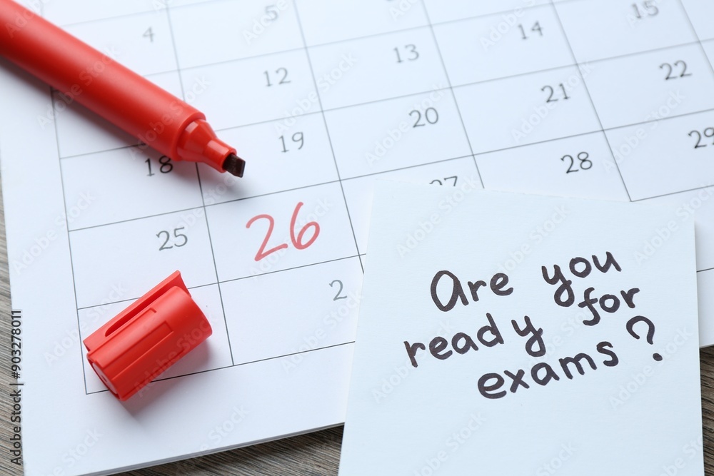Note with question Are You Ready For Exams, calendar and marker on wooden desk, closeup Note with question Are You Ready For Exams, calendar and marker on wooden desk, closeup