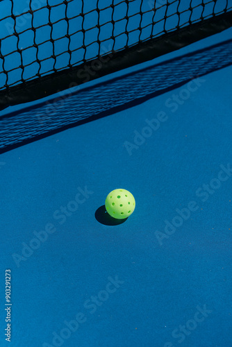 pickleball on a blue court