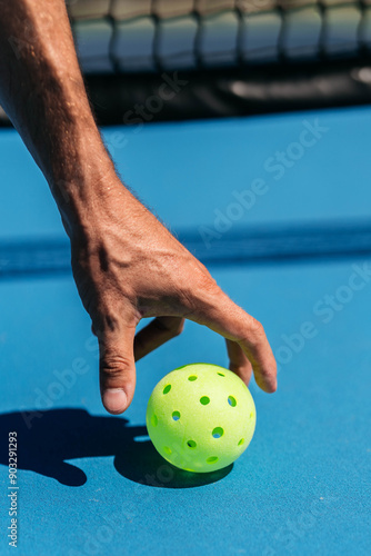 closeup of handle holding a pickleball