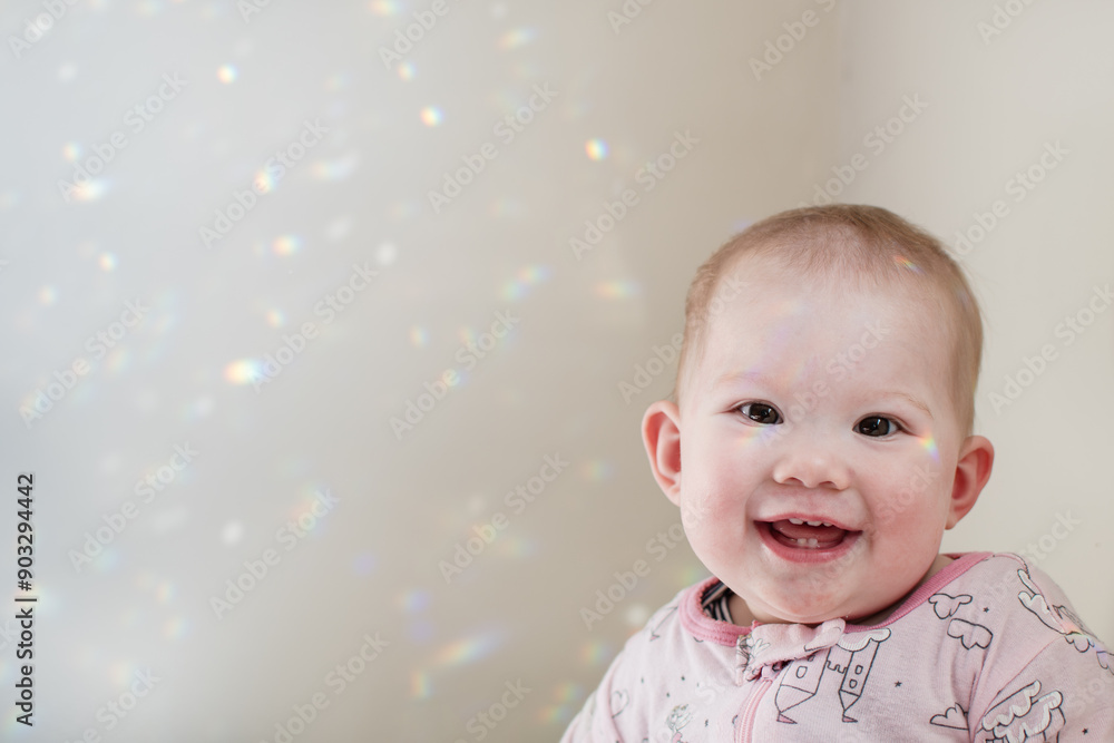 Portrait of a smiling happy baby looking at the camera with copy space. 8 month old baby girl Portrait of a smiling happy baby looking at the camera with copy space. 8 month old baby girl