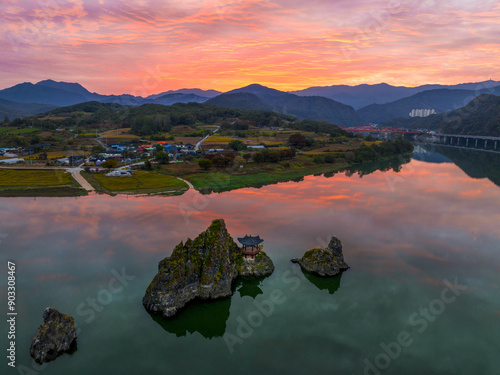 Aerial and sunrise view of Dodamsambong Peaks with pavilion on Namhan River against a village with house and field at Hagoe-ri near Danyang-gun, South Korea
 photo