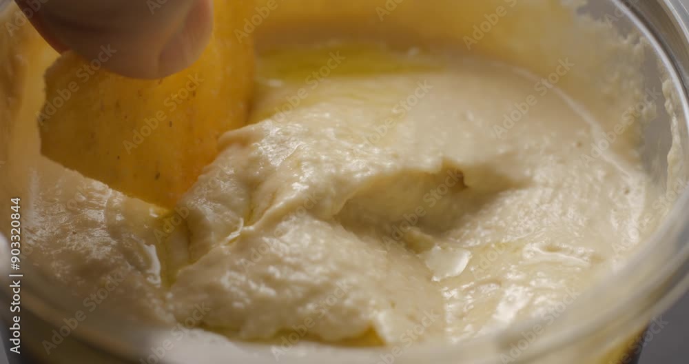 Houmous nachos dipping close-up slow motion Houmous nachos dipping close-up slow motion
