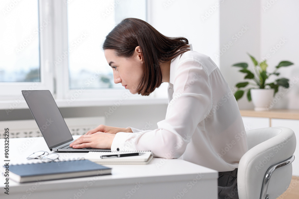 Woman with poor posture working in office Woman with poor posture working in office