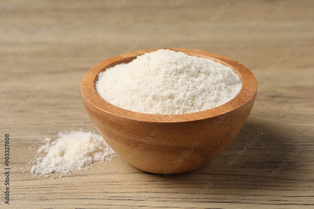 Fresh coconut flour in bowl on wooden table, closeup Fresh coconut flour in bowl on wooden table, closeup