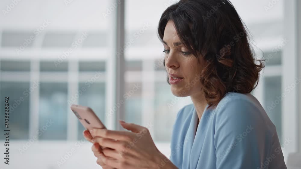 Positive woman worker texting smartphone sitting modern office space closeup. Positive woman worker texting smartphone sitting modern office space closeup.