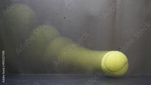Foto A tennis ball in motion, captured with a slow shutter speed black background