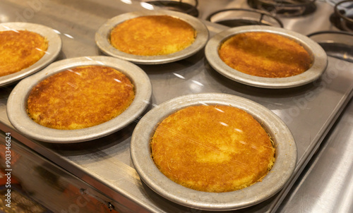 Knafeh Food, Sweet Cheese Pastry Made With Kadaifi, Traditional Arabic Dessert. Delicious Turkish Delight Kunefe On Metal Plate Behind Glass Case. Selective Focus, Horizontal Plane, photo