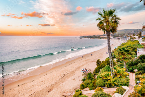Fototapeta Naklejka Na Ścianę i Meble -  Laguna Beach ocean shoreline with palm trees at Treasure Island Park, Orange County, California USA