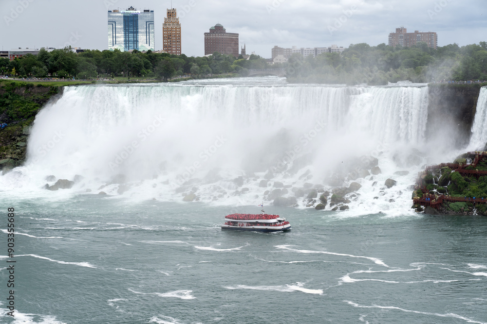 Fototapeta premium A tour boat cruises towards to mist at the base of the Horseshoe Falls in Niagara Falls Ontario.