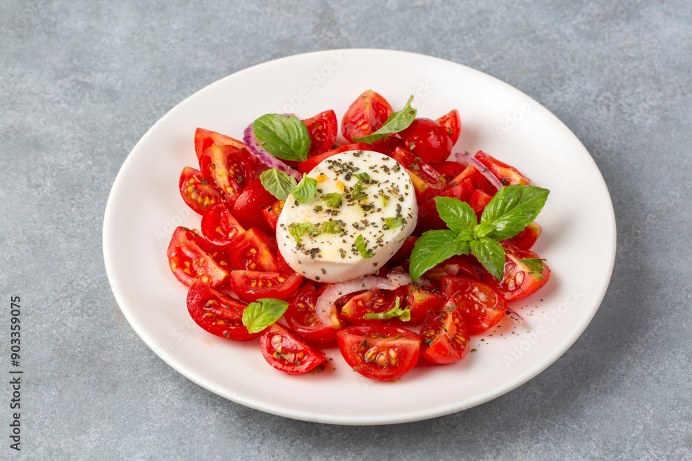 Italian caprese salad with sliced tomatoes, mozzarella, basil, olive oil