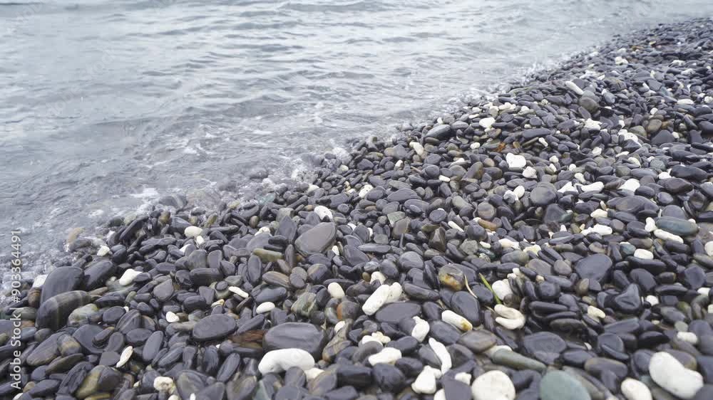 Granite gravel stone rocks flooring pattern surface texture on sea lake. Close-up of exterior material for design decoration background. Rubble Granite gravel stone rocks flooring pattern surface texture on sea lake. Close-up of exterior material for design decoration background. Rubble