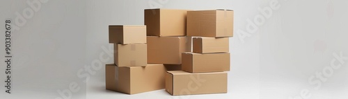 A stack of cardboard boxes in various sizes, arranged against a plain white background photo