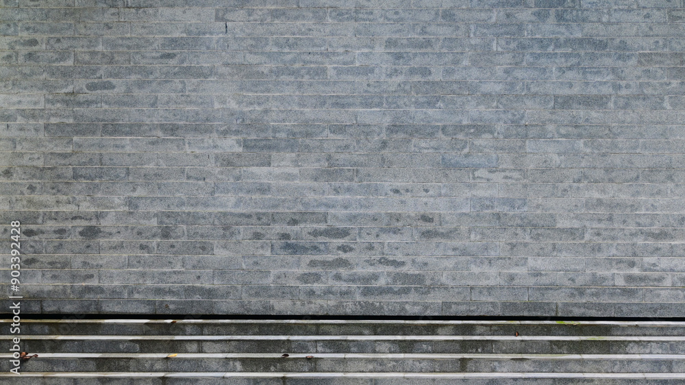 Fototapeta premium grey brick wall background design, construction industry