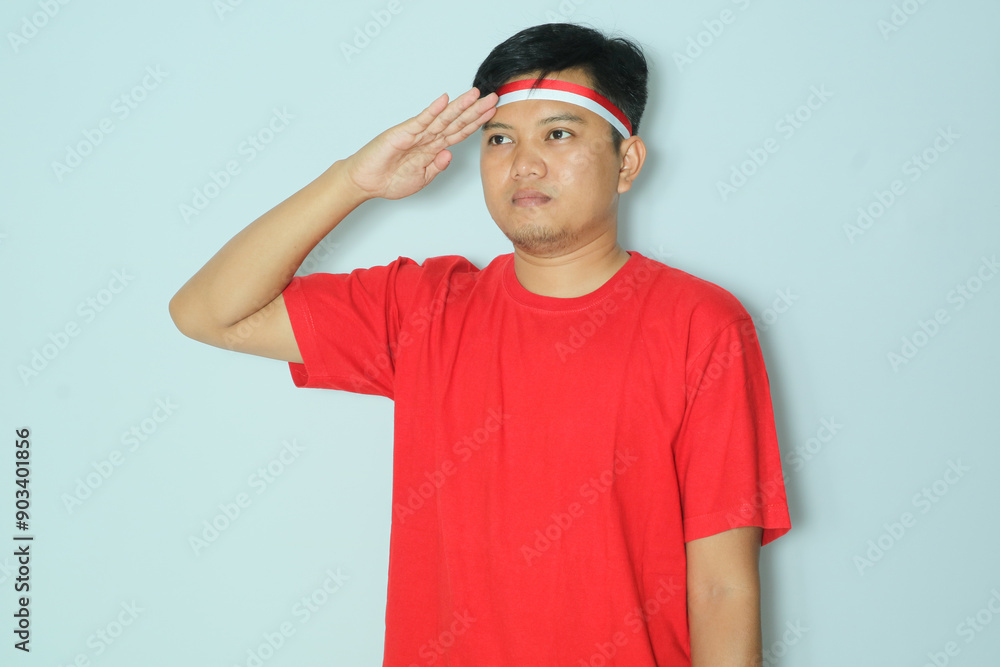 Fototapeta premium Indonesian man give salute pose. Wearing a red t-shirt