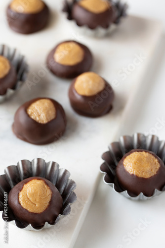 Smooth and Creamy Buckeye Chocolate and Peanut Butter Candies / Chocolates on White Background photo