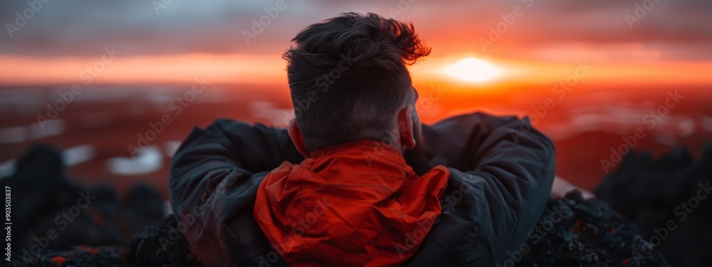 A person faced away from the camera with a sunset behind them and a cityscape in the distance A person faced away from the camera with a sunset behind them and a cityscape in the distance