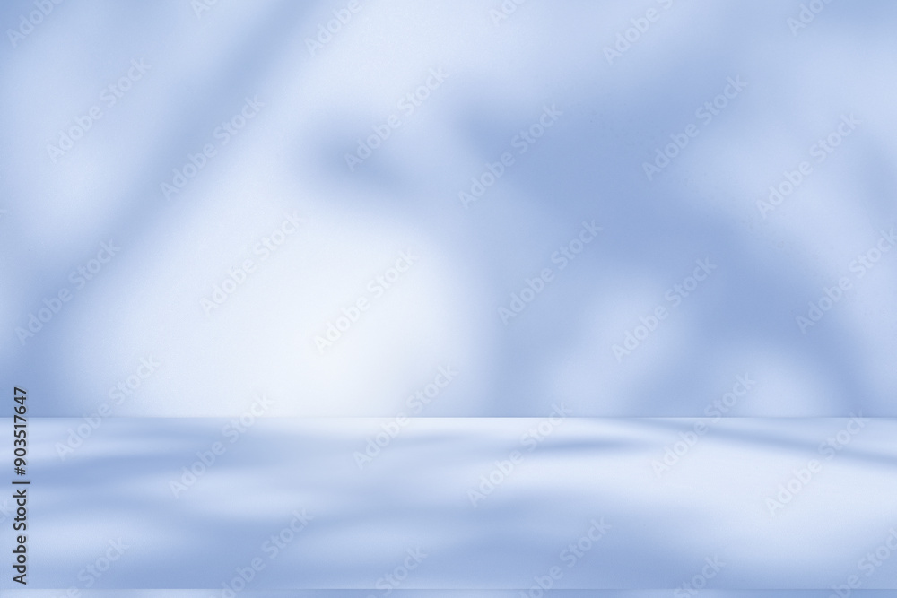 Obraz premium Studio style background wall decoration presentation uses white and blue tones. with shadows cast from a nearby window, concept creating a decorative backdrop.