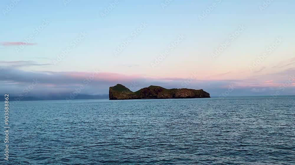 Wide view of distant secluded island Ellidaey with house and open ocean, Vestmannaeyjar, Iceland Wide view of distant secluded island Ellidaey with house and open ocean, Vestmannaeyjar, Iceland