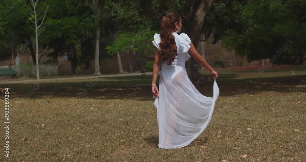 A young girl in a white outfit relishes a sunny day at the Botanical Gardens on the island of Trinidad in the Caribbean. A young girl in a white outfit relishes a sunny day at the Botanical Gardens on the island of Trinidad in the Caribbean.