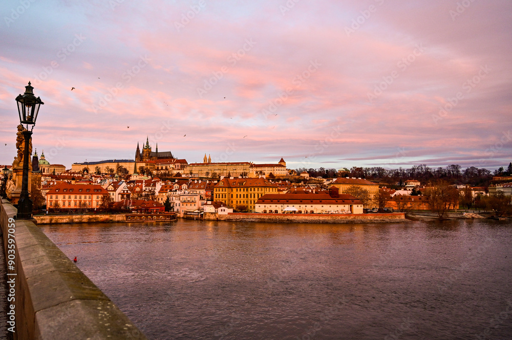 Fototapeta premium Prague at sunrise over the famous Charles Bridge Karluv most with panoramic view of the historic Prague Castle Prazsky hrad early morning with beautiful sky, Prague, Czech Republic