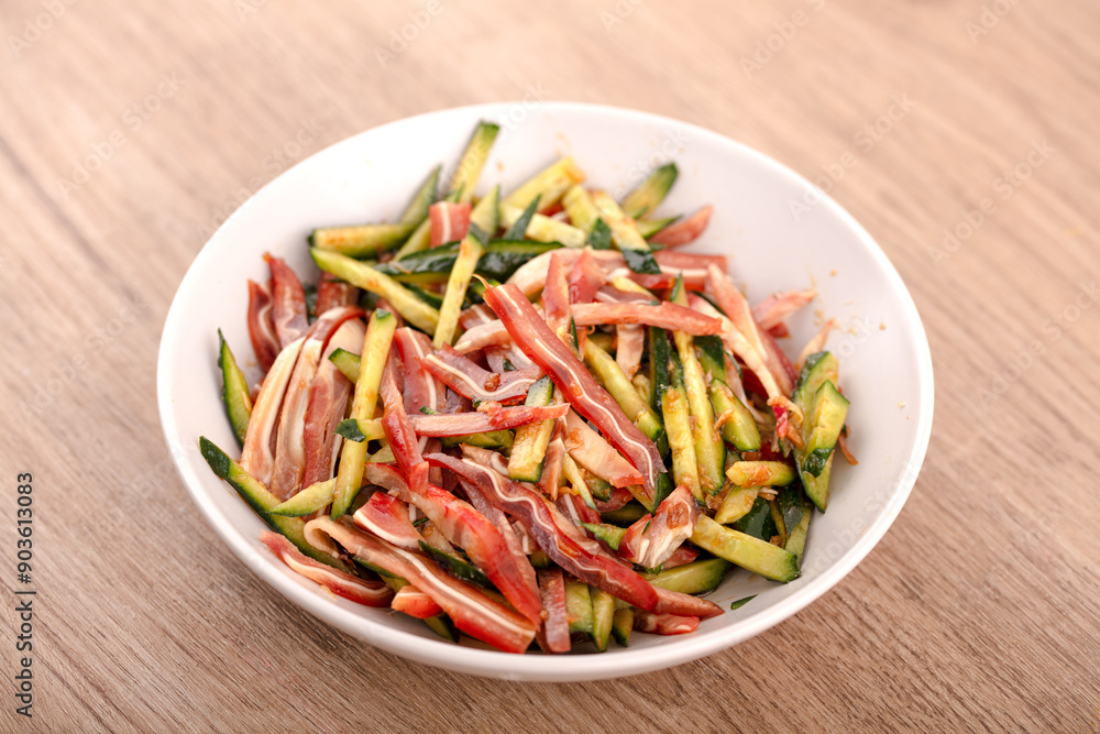 Sliced pig ears and cucumber shreds on the table Sliced pig ears and cucumber shreds on the table