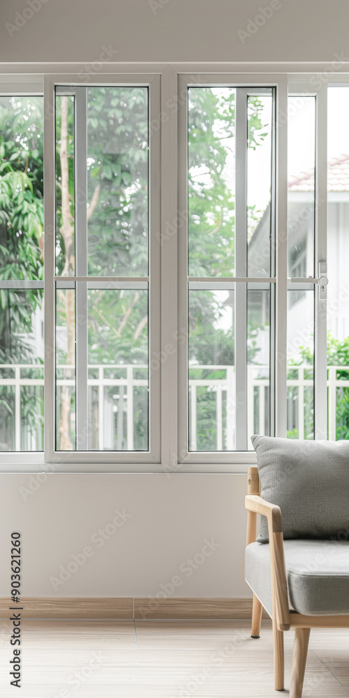 Fototapeta premium Property interiors design composition with minimal furniture, a mirror next to a large window and plain lighting. Elegant Residential interiors with copyspace.