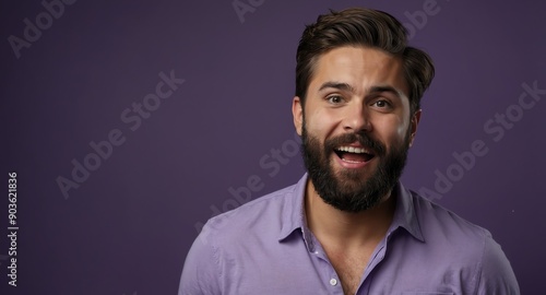 handsome bearded guy in plain purple background looking happy amazed surpised wow shocked expression with copy space © SevenThreeSky