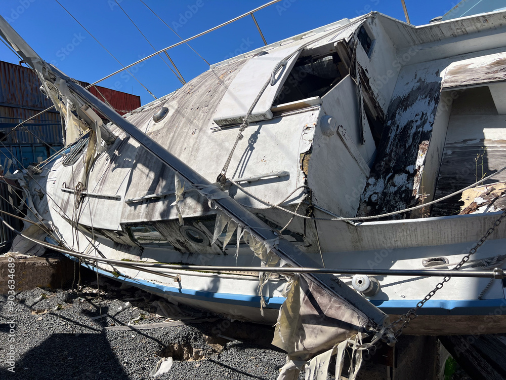 Destroyed yacht from tsunami seismic sea wave.