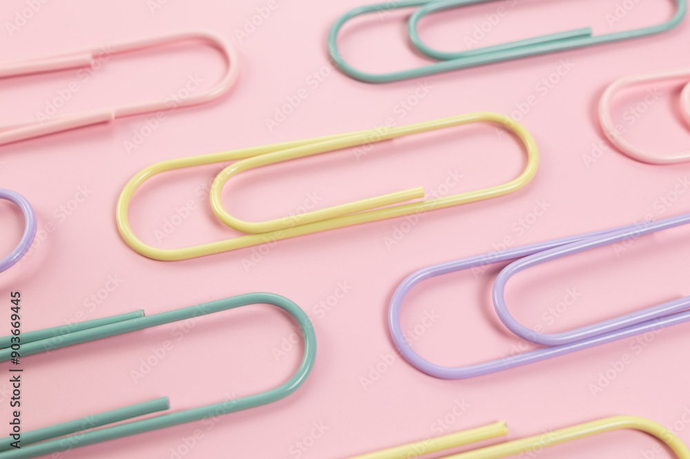 Top view of colorful paperclips on pink background. School, office wallpaper. Flat lay, copy space. Top view of colorful paperclips on pink background. School, office wallpaper. Flat lay, copy space.